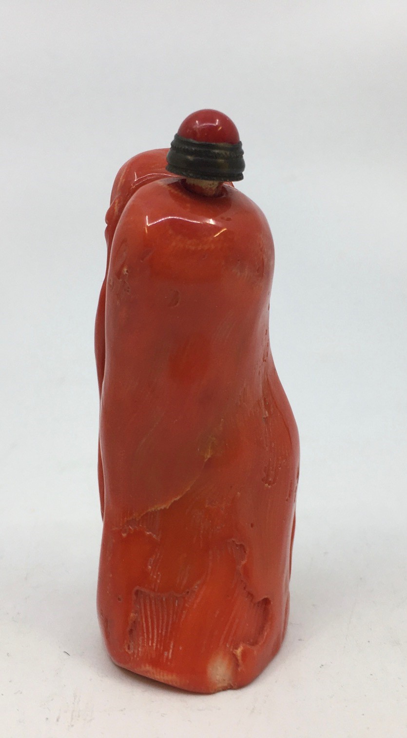 A Chinese carved pink coral scent bottle, carved as a standing figure, height with stopper 7. - Image 2 of 4