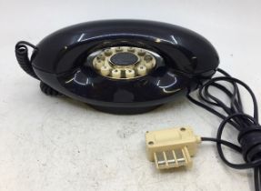 A vintage dark blue telephone