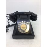 A vintage black bell telephone, (164 - 46/1), (332L, G.P.O., F.D.I., BATCH SAMPLED FWR66/2)