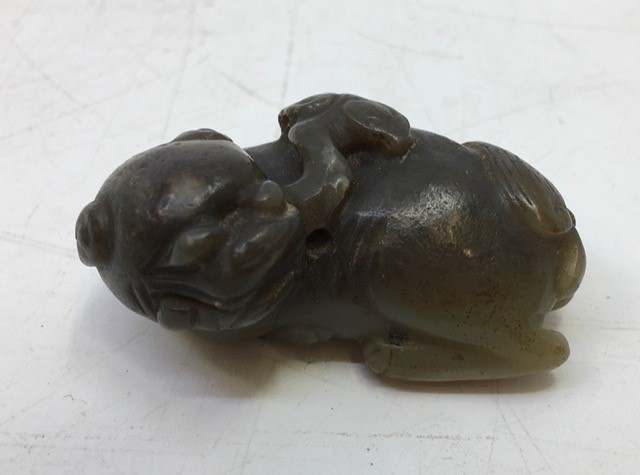 A Chinese spinach jade carved recumbent  beast