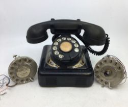 A vintage black bell telephone (Belglque, M F G Company, 2712-A-RB) together with spare parts