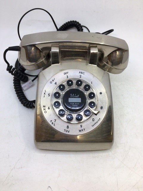 A vintage silver-coloured bell telephone