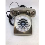 A vintage silver-coloured bell telephone