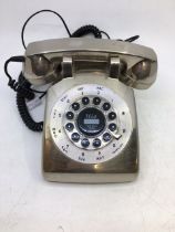 A vintage silver-coloured bell telephone
