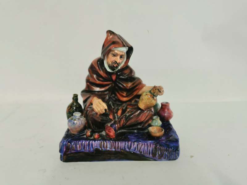 A Royal Doulton figure 'The Potter' HN1493 HS, 19cm high, 17cm wide and 13cm deep. In good