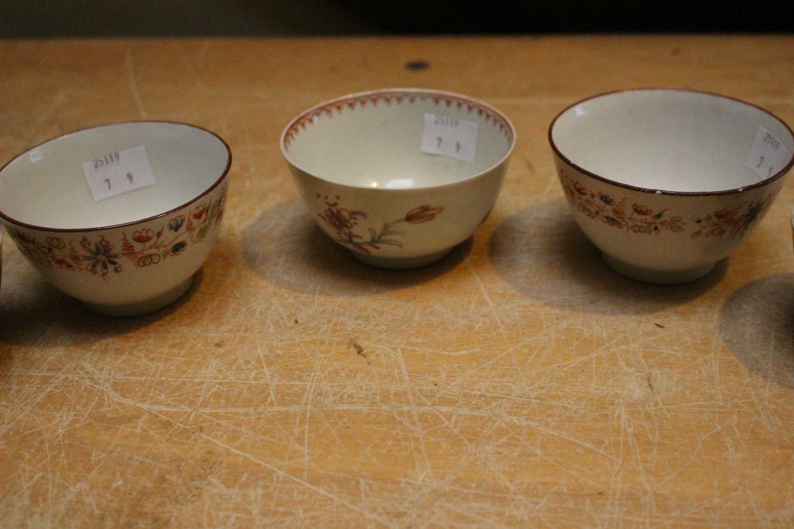 A set of three late 18th century Newhall tea bowls painted with flower sprays in famille rose - Image 3 of 3