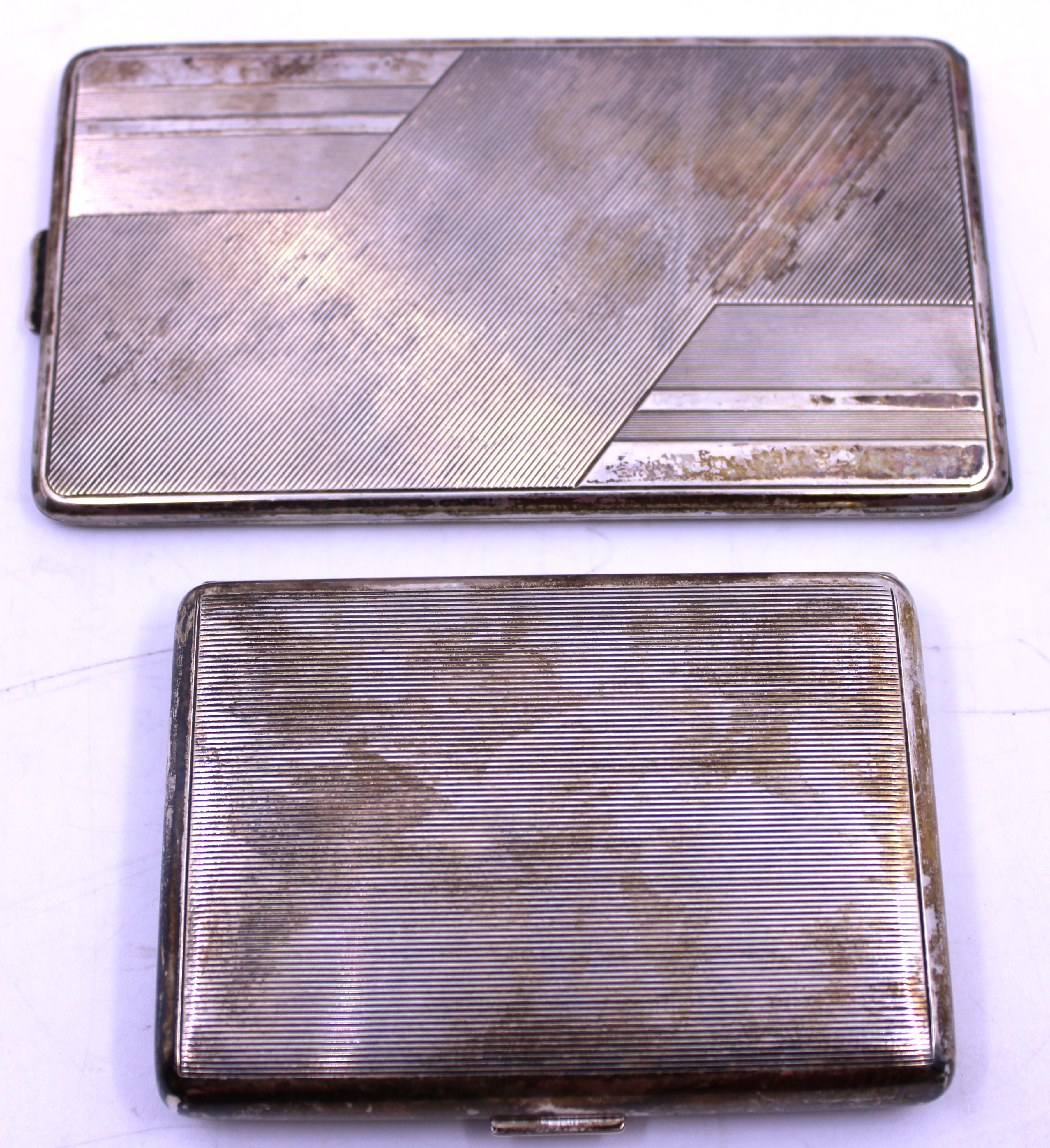 Two Norwegian Silver Cigaratte Cases.  One of the Cigarette Cases is marked "T.K 830 S" and is