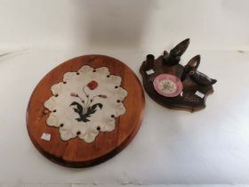 A pietra dura marble plaque inlaid with a flower, set into a wooden oval. Together with a carved