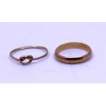 9ct Gold Wedding Band and 9ct Gold Knot Ring.   They are both hallmarked "375" for 9ct Gold.  The