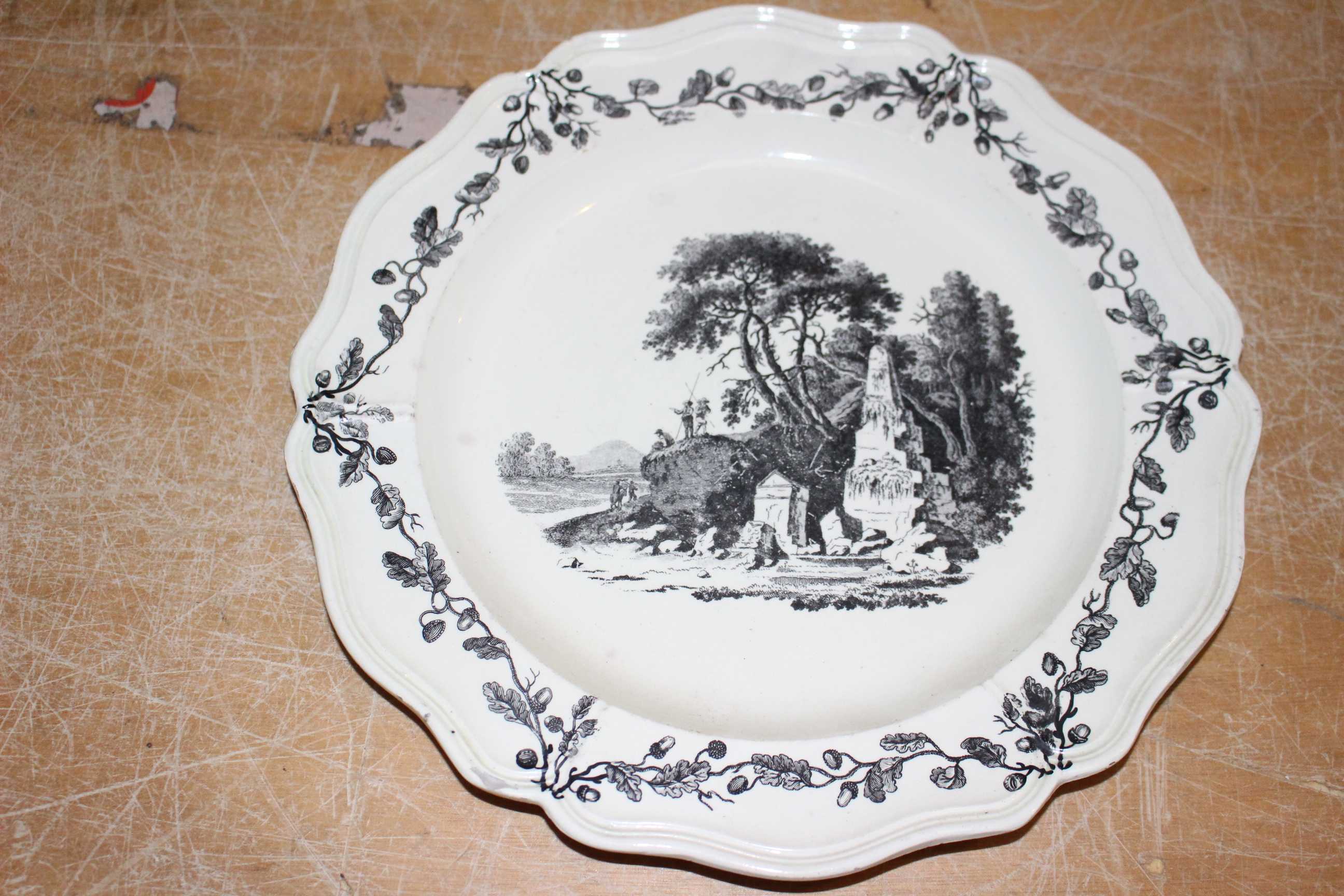 Two Liverpool Sadler and Green creamware plates printed in black with figures in landscapes, moulded - Image 3 of 4