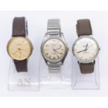 Selection of three Vintage Mechanical watches with clear plastic watch stands.  To include a Men's
