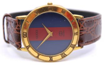 Vintage Gucci Gold Plated Quartz Watch. Red & Blue Dial that measures approx. 33mm x  33mm.  The
