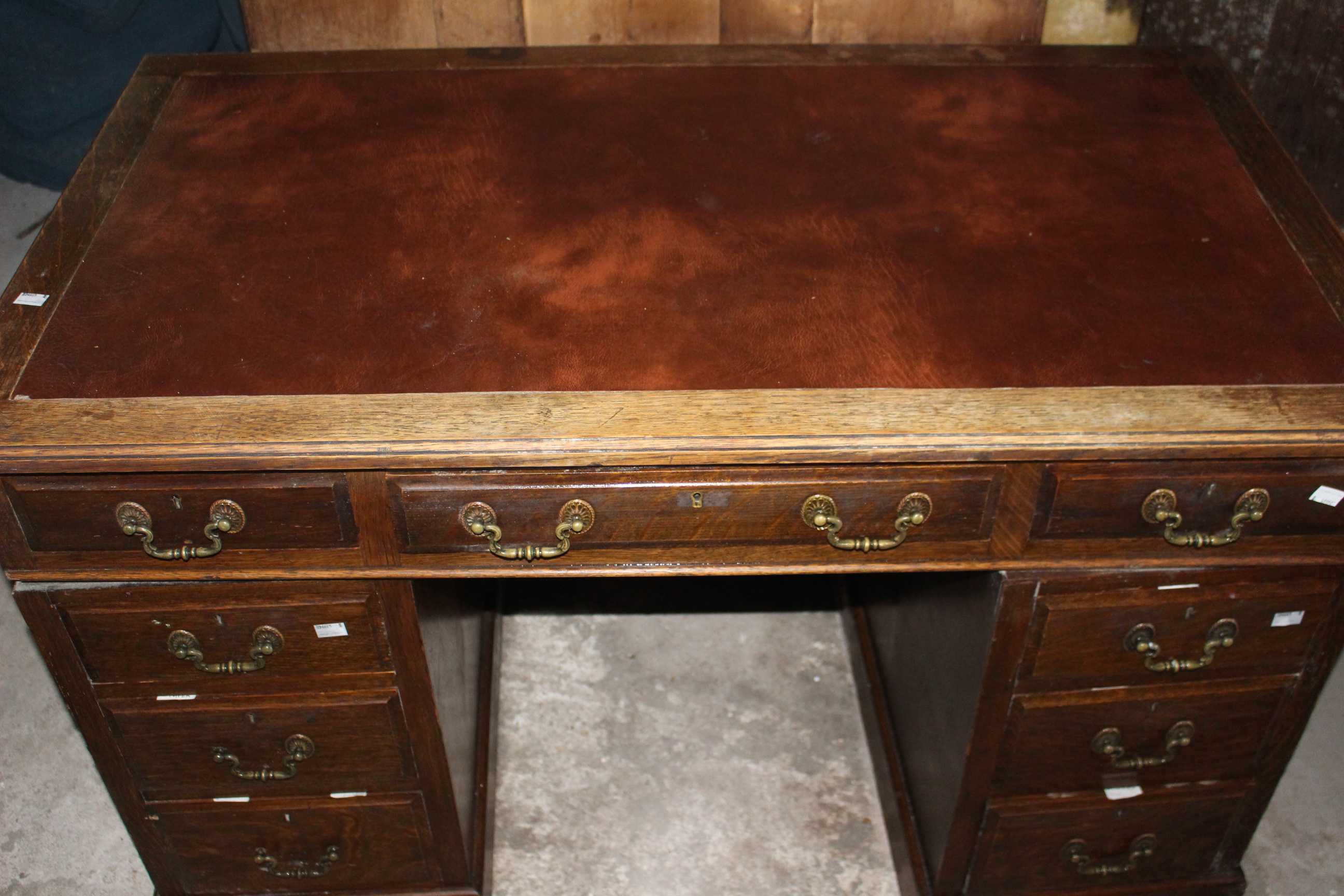 An antique twin pedestal oak desk with red leather top and brass handles. 122cm wide and 69cm - Image 2 of 5