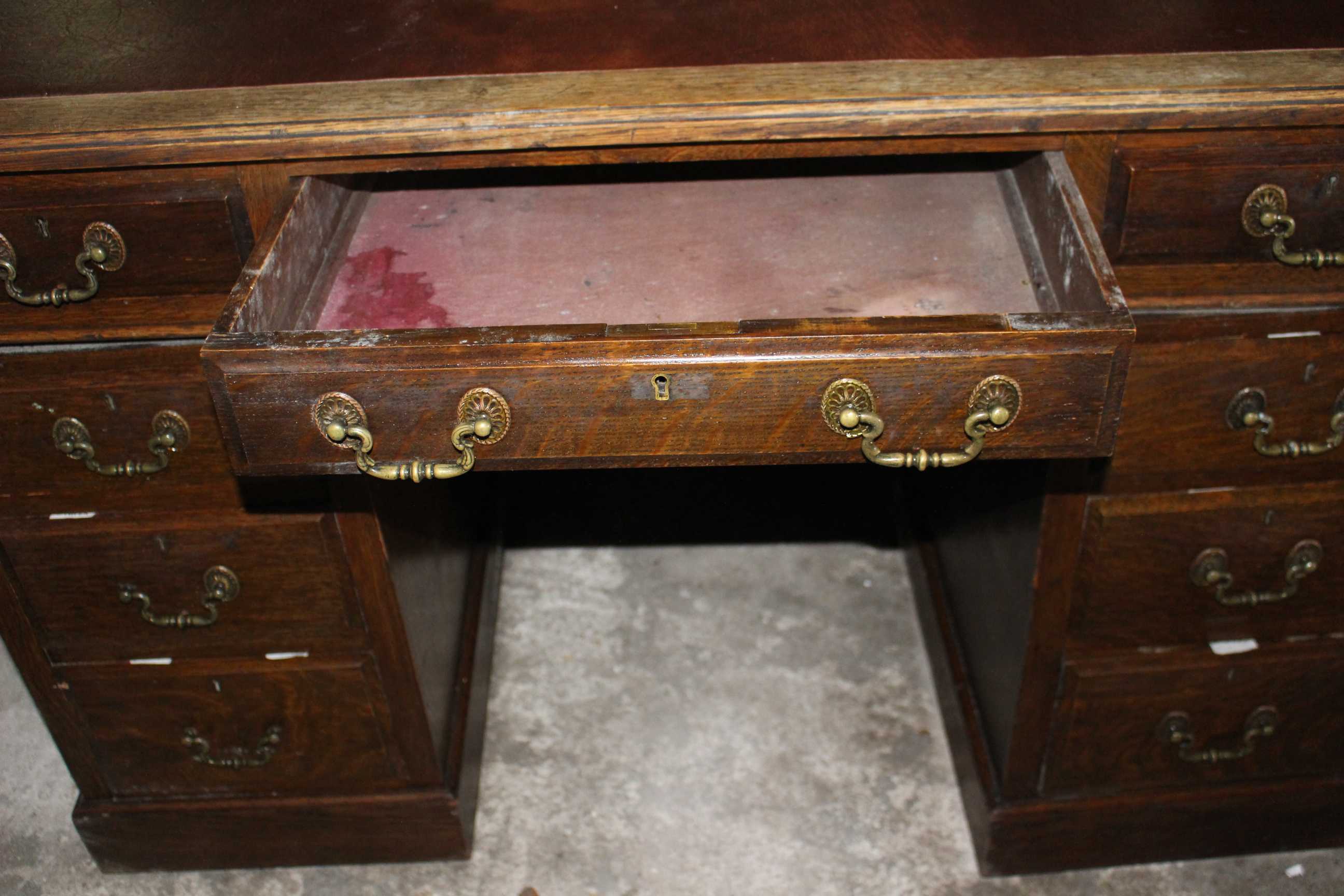 An antique twin pedestal oak desk with red leather top and brass handles. 122cm wide and 69cm - Image 3 of 5