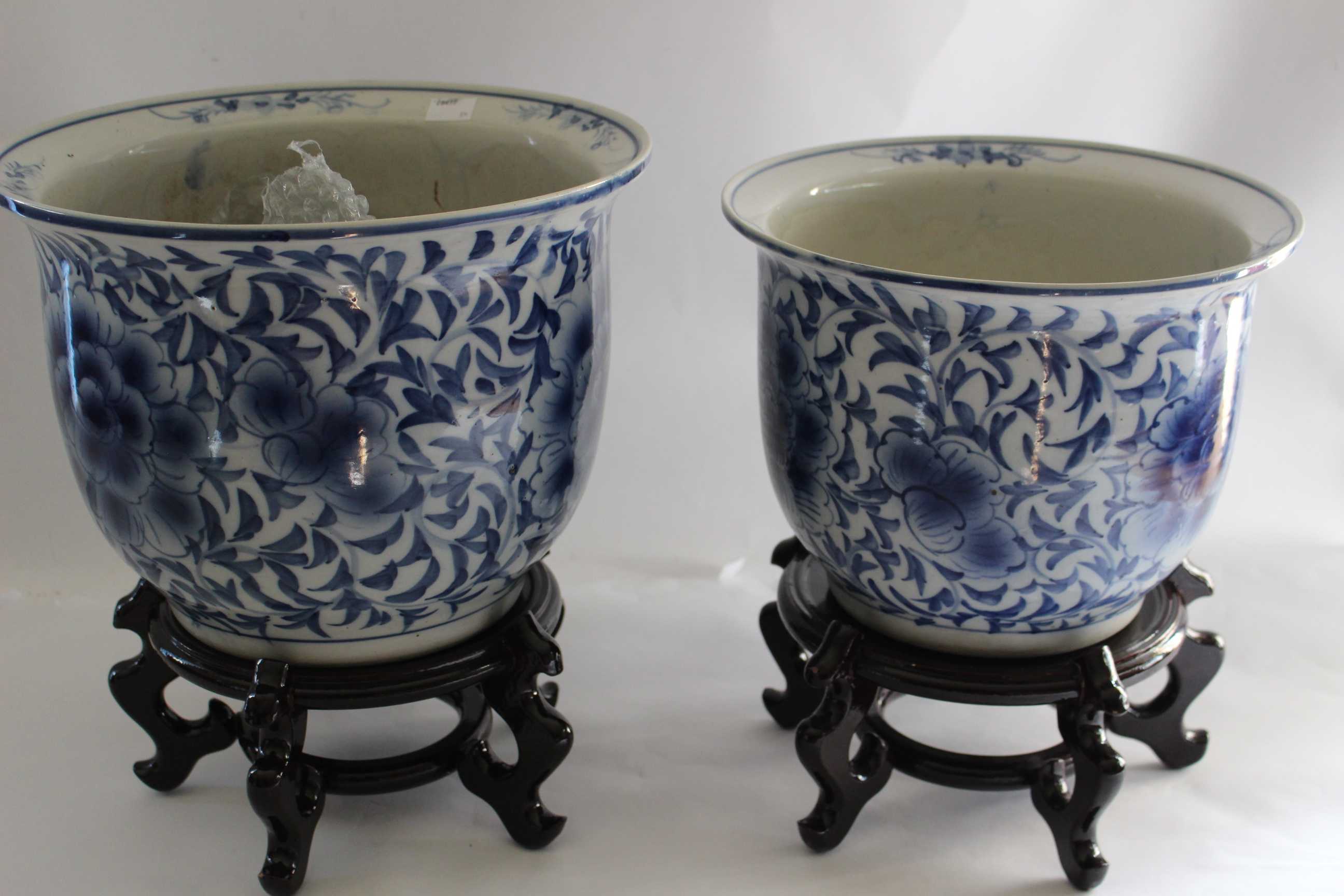 Two Chinese Hand painted Blue and White porcelain Jardinière and stand. Circa 1900.