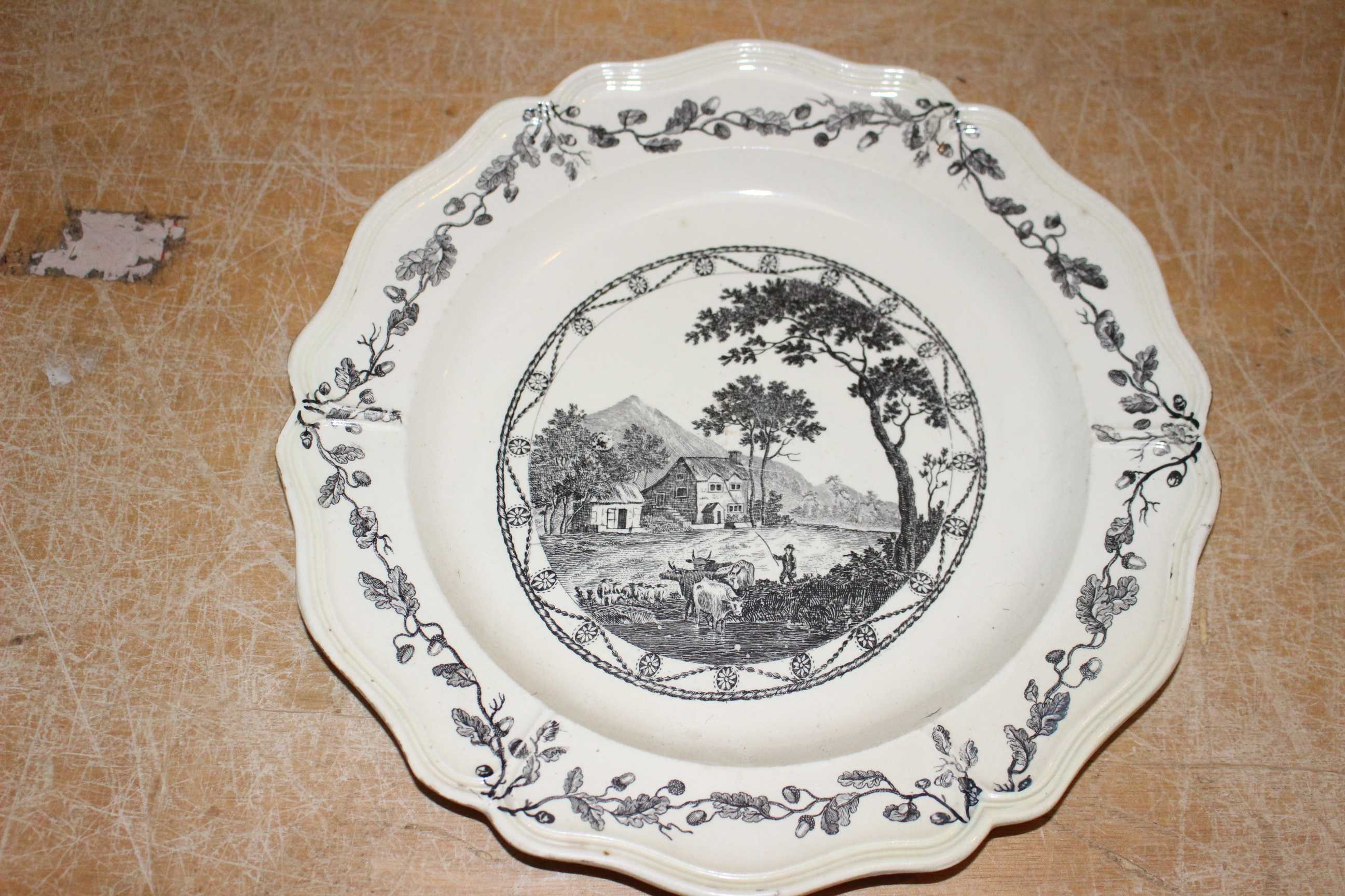 Two Liverpool Sadler and Green creamware plates printed in black with figures in landscapes, moulded - Image 4 of 4