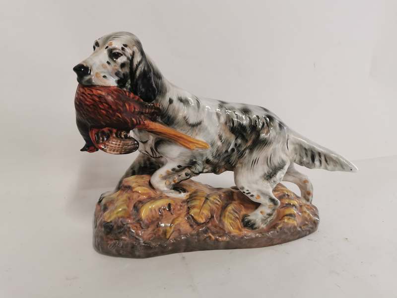 A Royal Doulton bone china figure of a spaniel holding a pheasant while standing HN 2529. 28cm