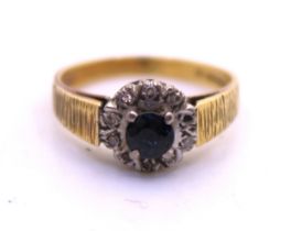 18ct Yellow Gold Sapphire & Diamond Ilusion Set Ring. The Round Brilliant Cut Sapphire measures