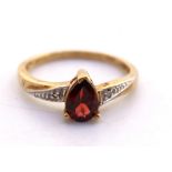 9ct Yellow Gold Pear Cut Garnet and Diamond Ring.  The Garnet measures approx. 7mm in length and