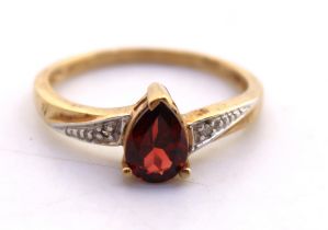9ct Yellow Gold Pear Cut Garnet and Diamond Ring.  The Garnet measures approx. 7mm in length and
