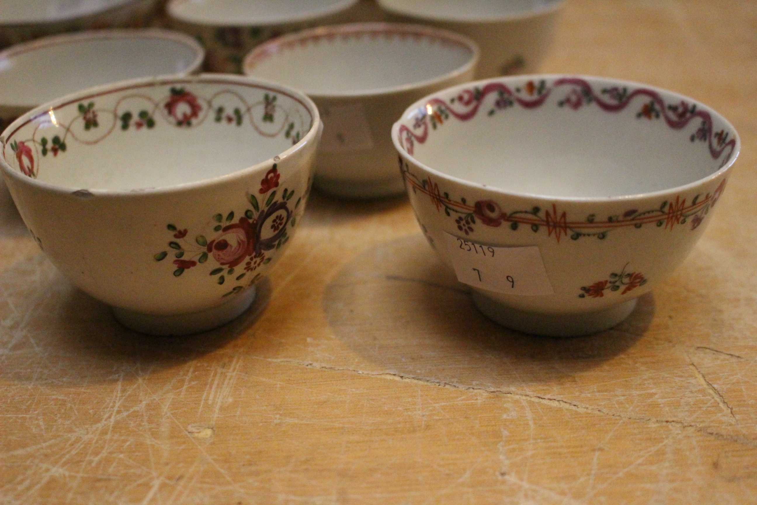 A set of three late 18th century Newhall tea bowls painted with flower sprays in famille rose - Image 2 of 3