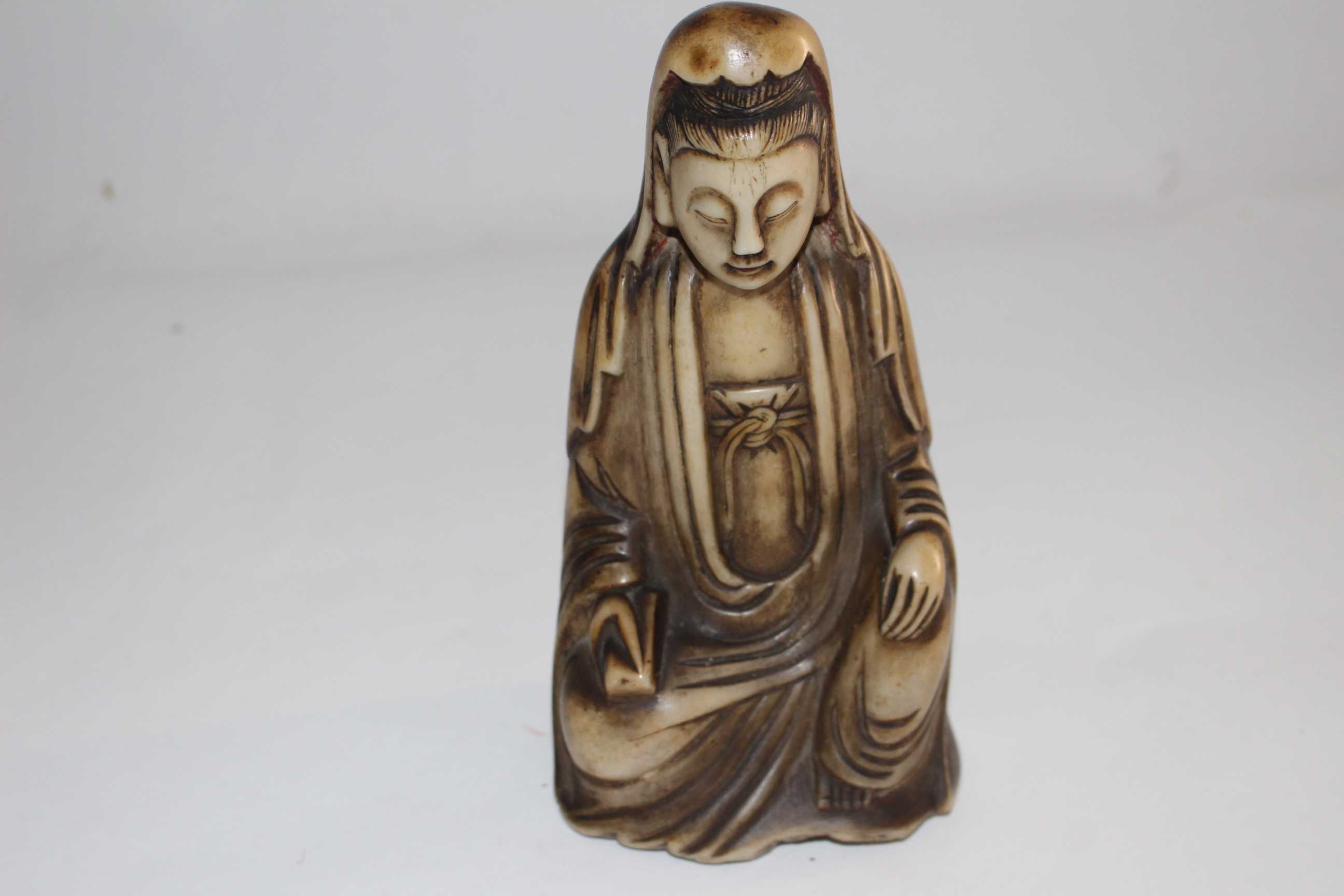 A Qing Dynasty Carved Soapstone figure of Guanyin.  Modelled seated in 'royal ease' with a serene - Image 2 of 3