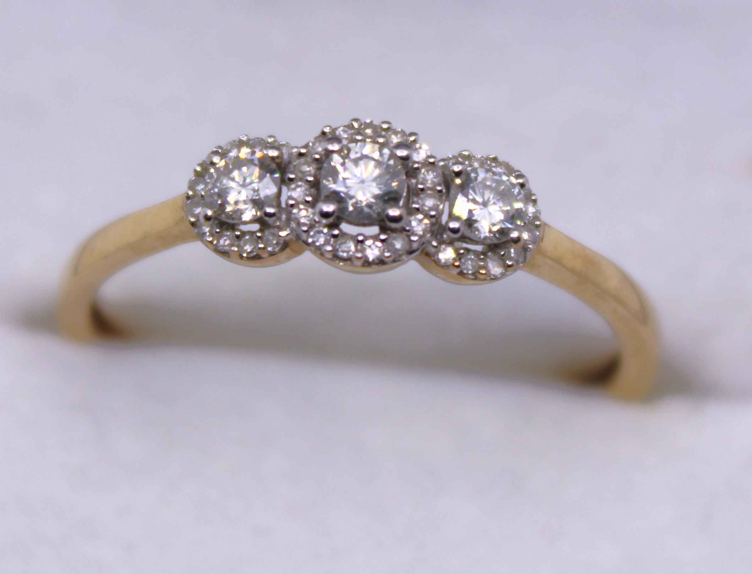 9ct Yellow Gold Three Stone Round Brilliant Cut Diamond ring with surrounding Round Brilliant Cut