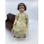 Antique German miniature 9” bisque head fully articulated doll with fixed glass eyes in antique