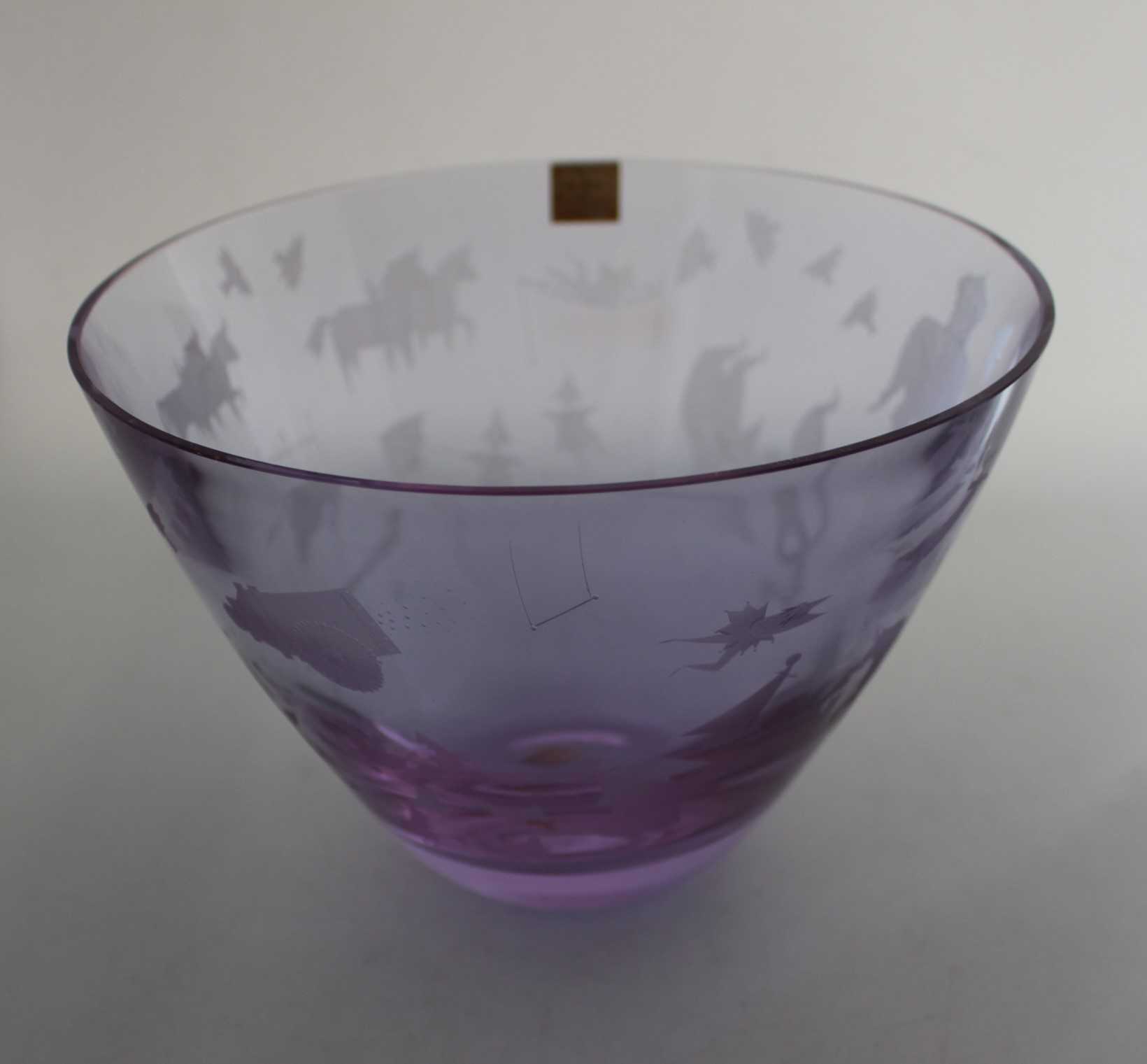 A Caithness pale amethyst glass "Circus" bowl with engraved decoration, etched signature C.B.