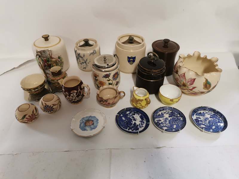 A collection of pottery tobacco jars together with other pottery items to include small gilt cream