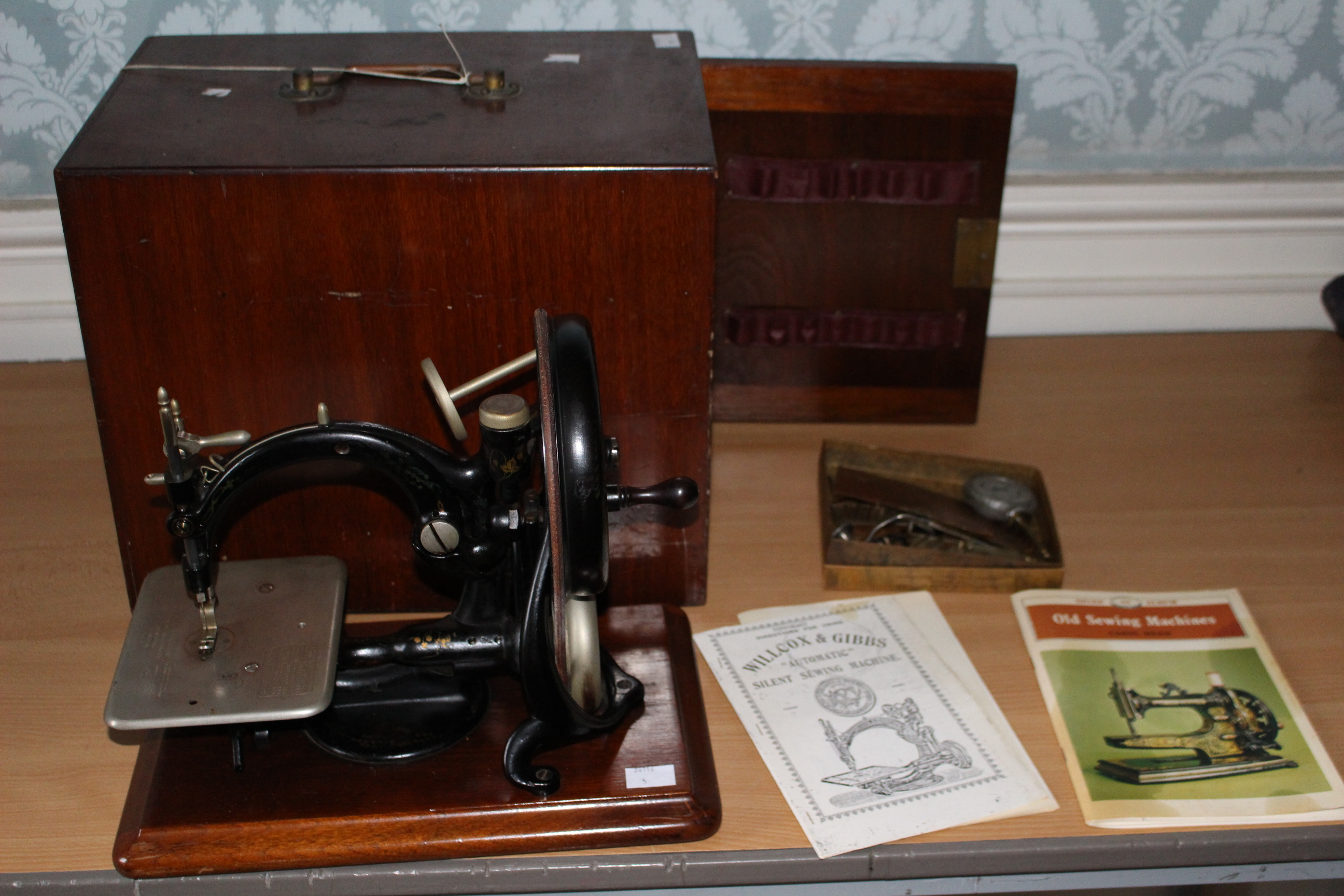 A Willcox and Gibbs silent sewing machine, late 19th century with lockable box and instructions