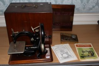 A Willcox and Gibbs silent sewing machine, late 19th century with lockable box and instructions