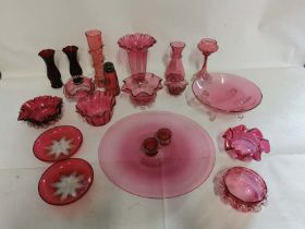 A collection of Victorian and later cranberry glass items, to include; vases, dishes, salts etc.  (