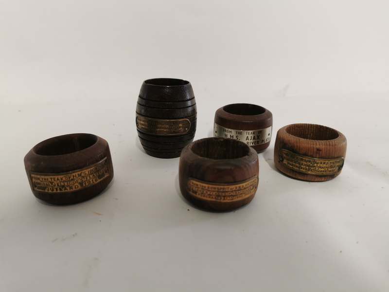 4 wooden napkin rings with plaques stating they are from the ships; x2 HMS Victory, HMS Iron Duke,
