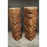 A pair of South American carved totem figures, 30cm high