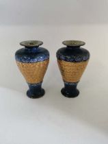 A pair of Doulton Lambeth vases with blue glaze to the top and bottom and a gold swirl pattern to