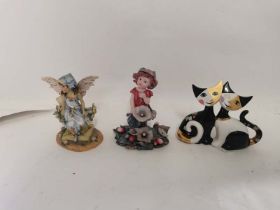 A porcelain Goebel cat figure together with two figures of fairies. (3)