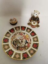 A Royal Crown Derby 'Drummer Bear' paperweight together with a trinket pot and dinner plate of the