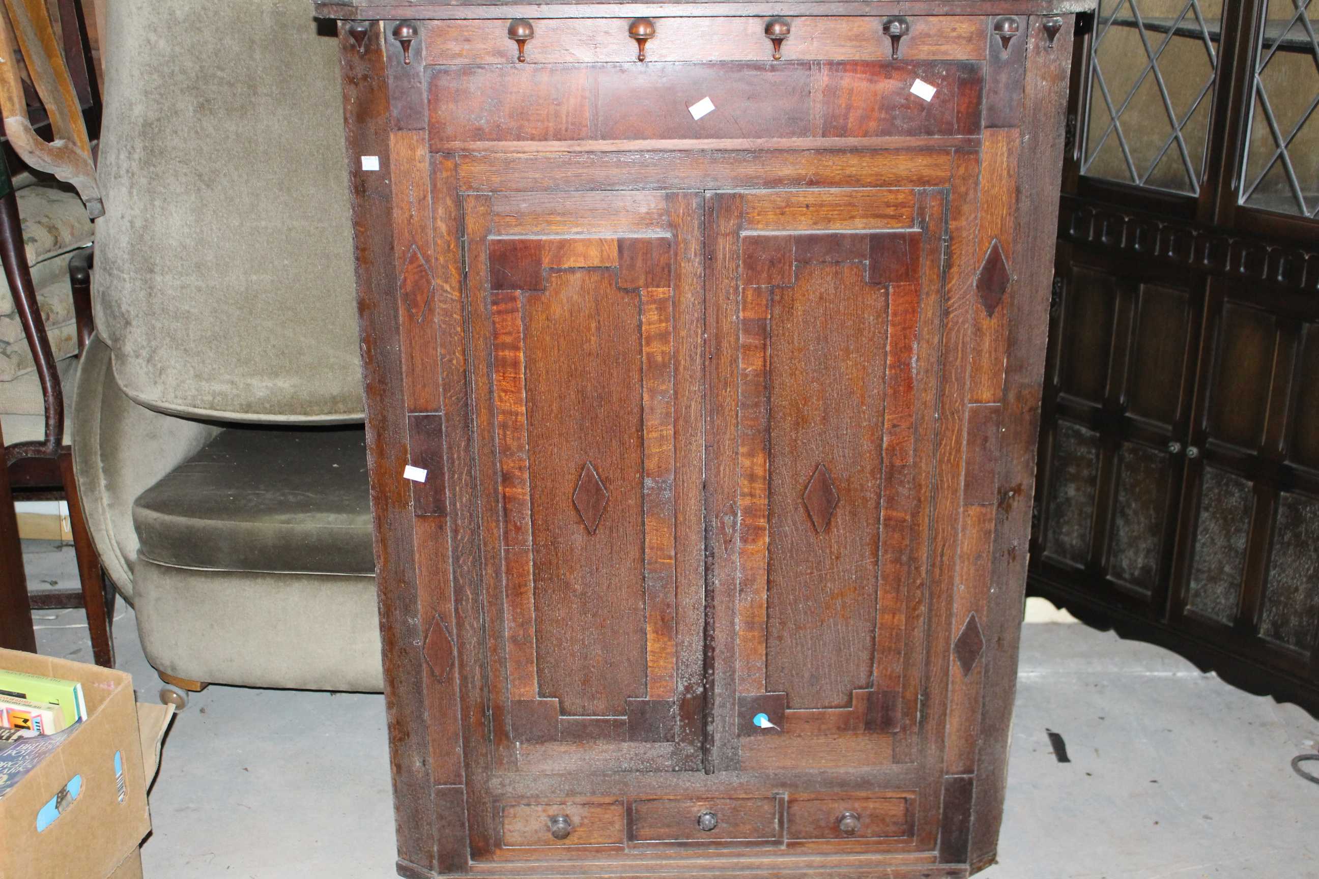 A Georgian oak and inlaid corner cabinet. (1)