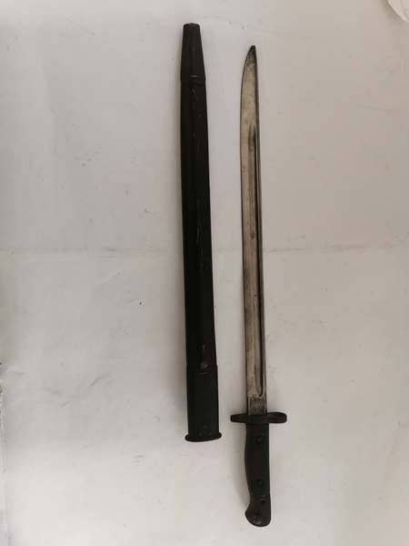 A First World War bayonet with a Wilkinson Blade dated 1907, with leather sheath. (1)