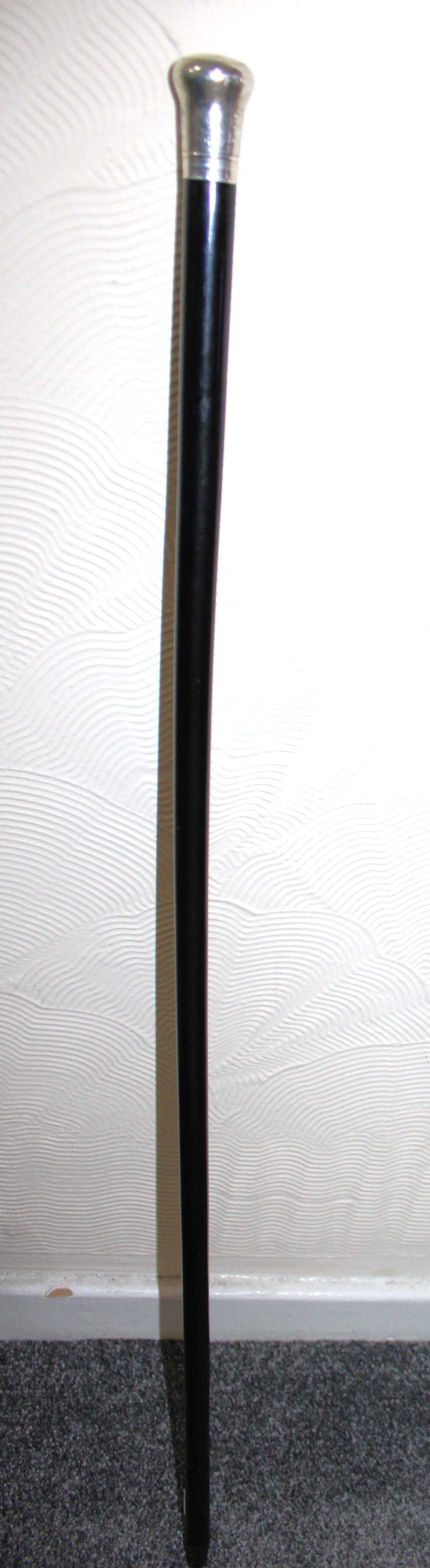 A Sterling Silver Topped Ebony Walking Stick/Cane.  The Sterling Silver Top has the makers marks "