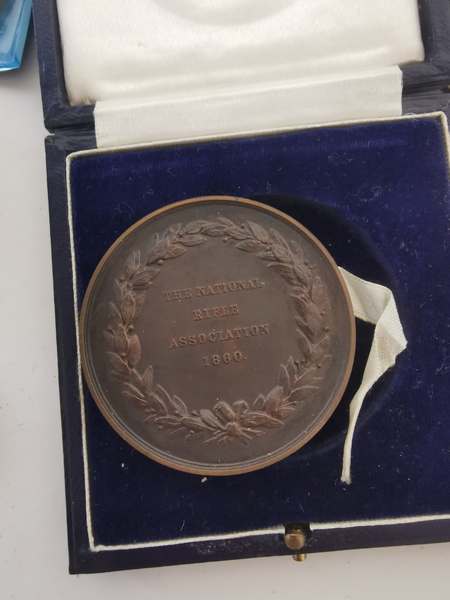 The National Rifles Association 1880 bronze coin together with three £5 coins and other Victorian - Image 2 of 2