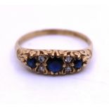 9ct Yellow Gold Sapphire and Illusion Set Diamond Ring.  The Total Carat Weight of the Three Round