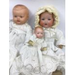 Antique dolls trio to include a dream baby with bisque head  with original shaped stitched baby body