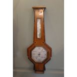 A 1930's Art Deco aneroid barometer in an inlaid walnut case 66cm high