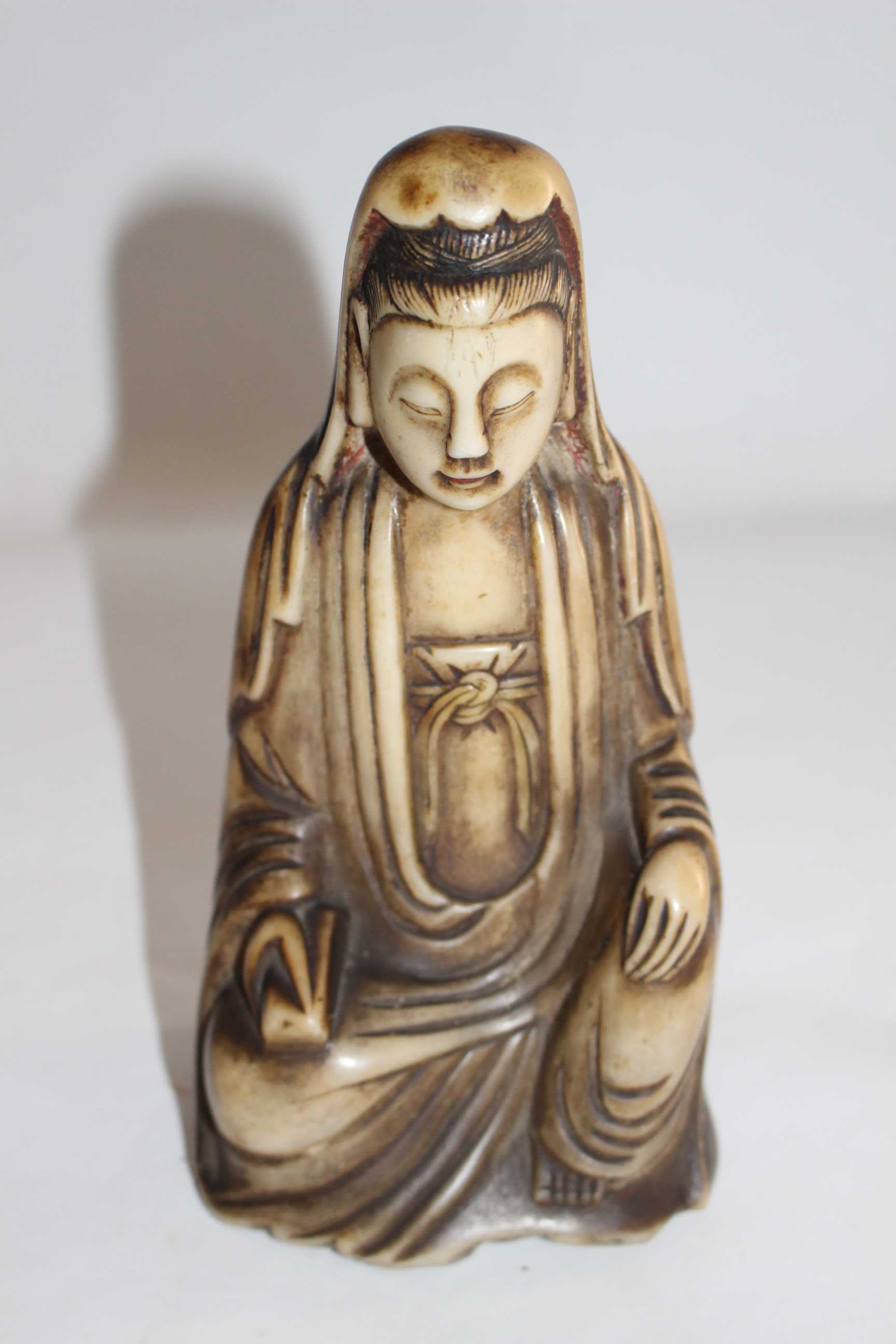 A Qing Dynasty Carved Soapstone figure of Guanyin.  Modelled seated in 'royal ease' with a serene