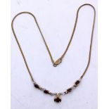 9ct Gold Garnet & Diamond Necklace.  The Necklace contains five Oval Brilliant Cut Garnets.  The