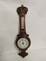 A carved oak cased aneroid barometer circa 1900. 74cm high. In good condition. (1)