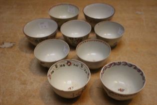 A set of three late 18th century Newhall tea bowls painted with flower sprays in famille rose