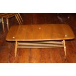 Ercol Blonde coffee table with magazine rack good used condition but small chip to one corner.